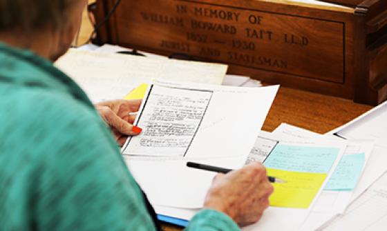 View of papers on desk over shoulder of researcher