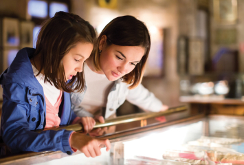 Mom and daughter looking at display