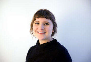 Image of Sarah Quiat, wearing black shirt with hair back.