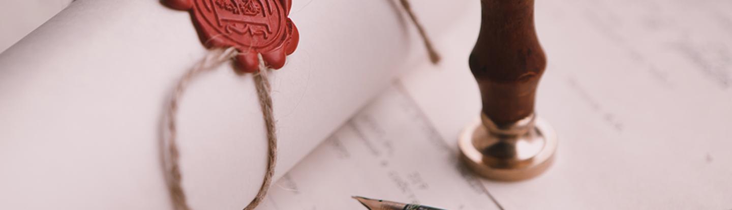 Scroll with wax seal arranged on desk