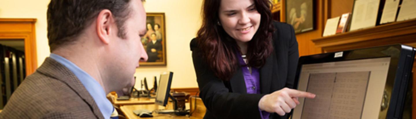 Expert shows researcher record on a computer screen