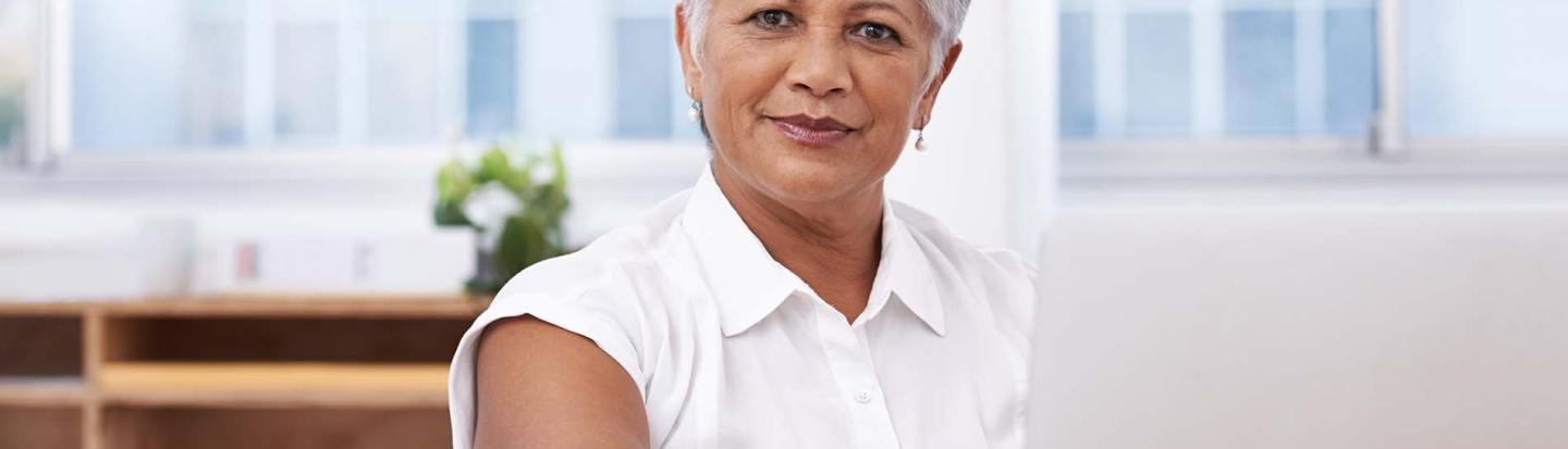 woman with short hair on laptop