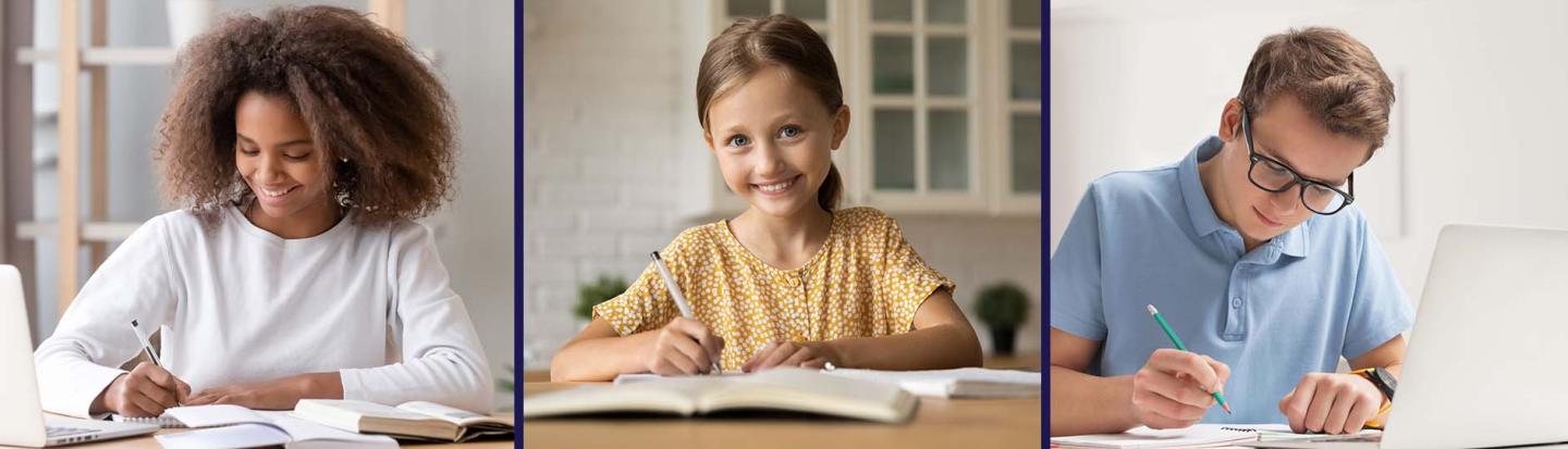 Young students seated at tables writing in notebooks