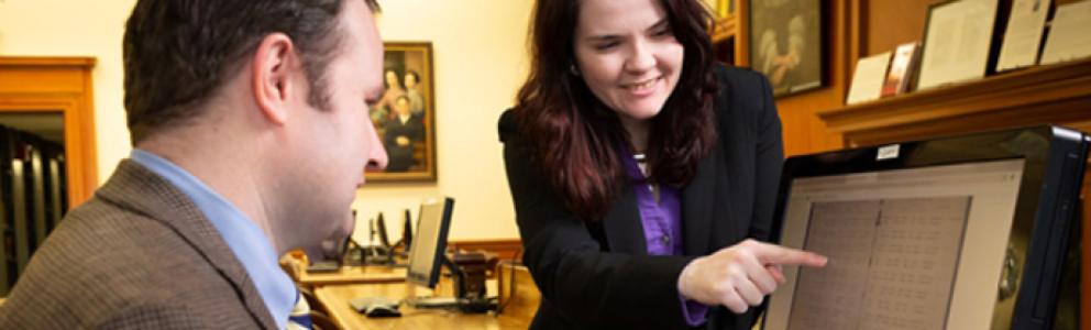 Expert shows researcher record on a computer screen