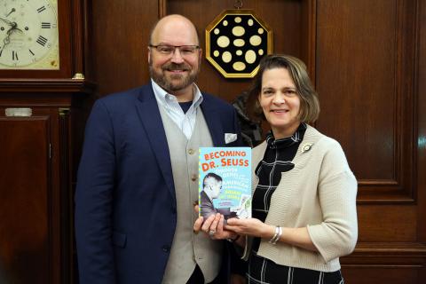 Brian Jay Jones poses with Margaret Talcott and Becoming Dr. Seuss book