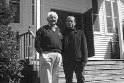 Vintage photo of two family members outside house