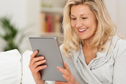 Researcher uses tablet on couch at home