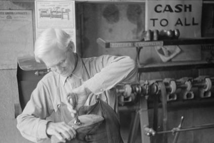 Black and white photo of a man using tools