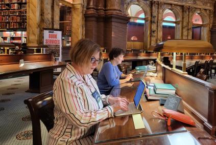 women doing research in a library