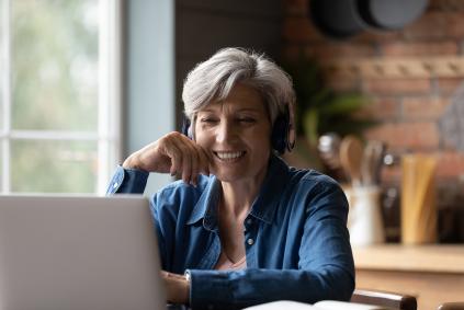 Woman learning What’s New at American Ancestors woman on laptop at home